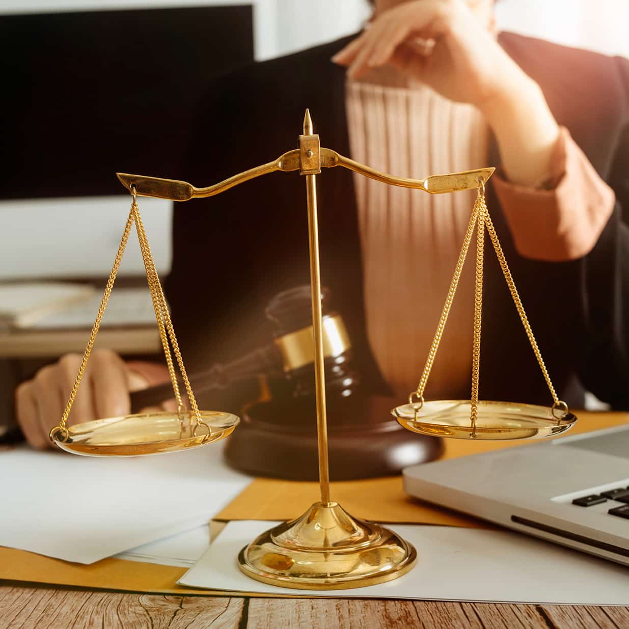 Business and lawyers discussing contract papers with brass scale